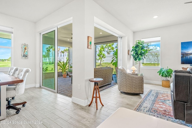 interior space with light hardwood / wood-style flooring, ceiling fan, and a healthy amount of sunlight