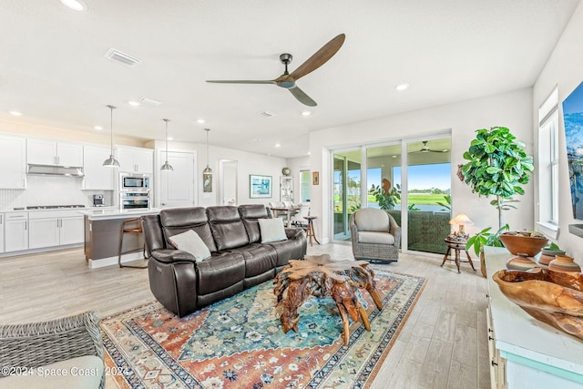 living room featuring light wood-type flooring and ceiling fan