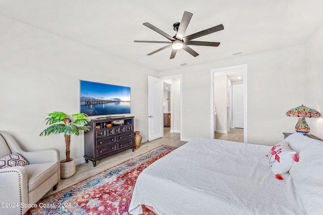 bedroom with ceiling fan and light hardwood / wood-style flooring