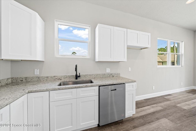 kitchen featuring dishwasher, sink, light hardwood / wood-style flooring, light stone countertops, and white cabinetry