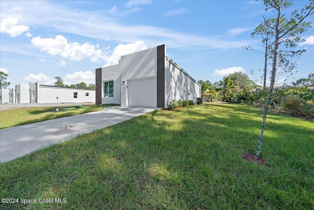 view of home's exterior featuring a yard and a garage