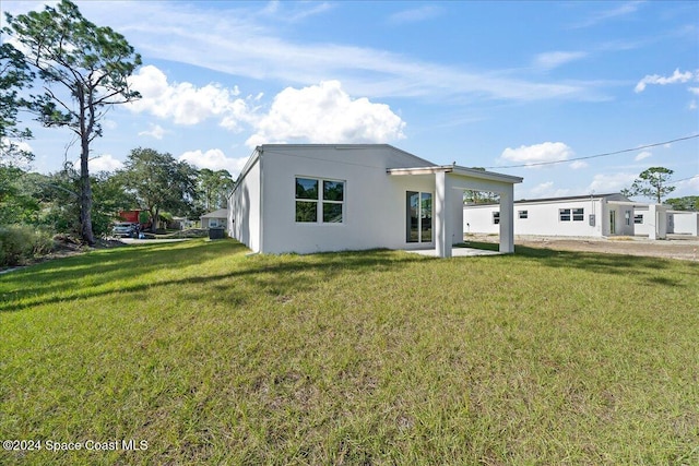 rear view of house with a lawn