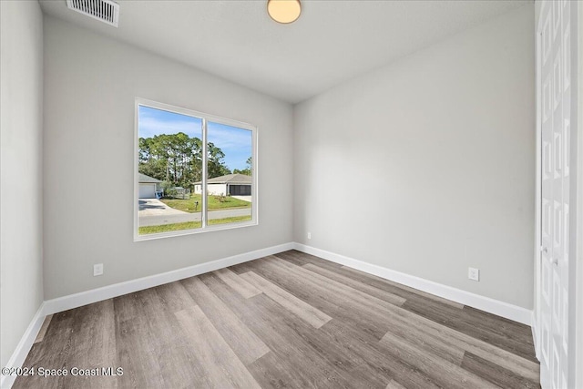 empty room with hardwood / wood-style floors