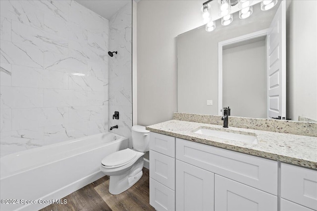 full bathroom with wood-type flooring, vanity, toilet, and tiled shower / bath