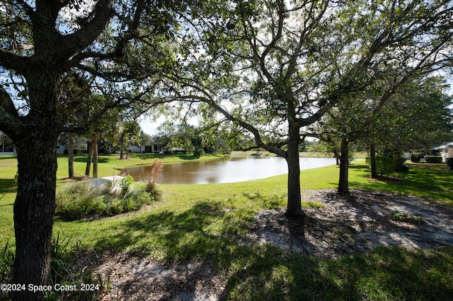 exterior space featuring a yard and a water view