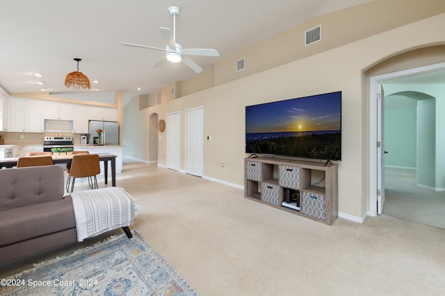 carpeted living room featuring ceiling fan and lofted ceiling