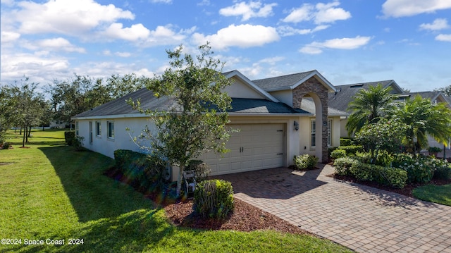 ranch-style house with a front yard and a garage