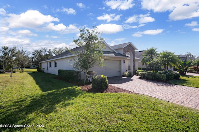 view of front of home with a garage and a front yard