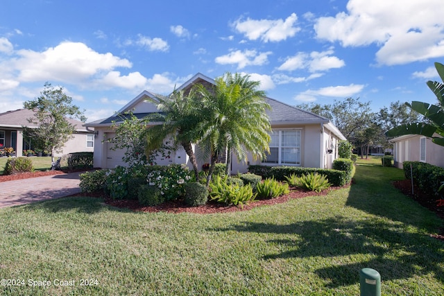 view of front of home with a front yard and a garage