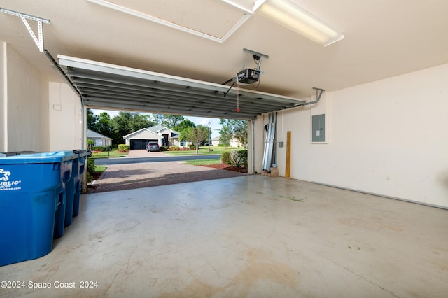 garage featuring a garage door opener and electric panel