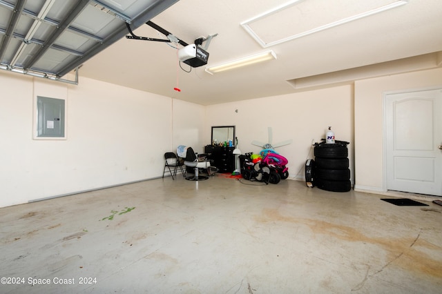 garage with a garage door opener and electric panel