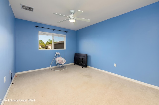 unfurnished room with ceiling fan and light colored carpet