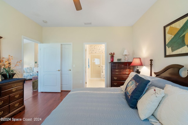 bedroom with ceiling fan, dark wood-type flooring, and ensuite bathroom