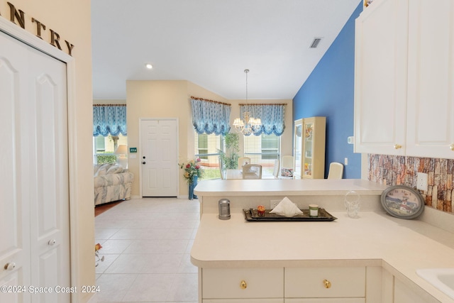 kitchen with a notable chandelier, decorative light fixtures, plenty of natural light, and kitchen peninsula