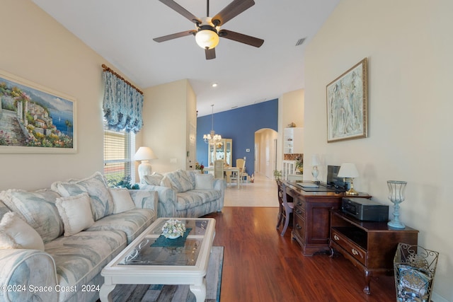 living room with ceiling fan with notable chandelier, dark hardwood / wood-style floors, and vaulted ceiling