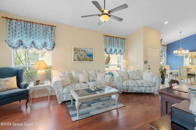 living room with ceiling fan with notable chandelier and dark wood-type flooring