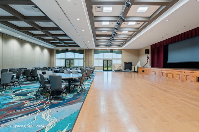 dining room with coffered ceiling, beam ceiling, and hardwood / wood-style floors