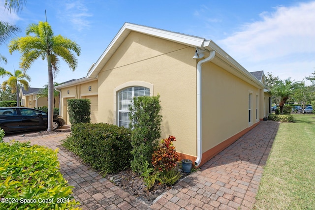 view of property exterior featuring a lawn