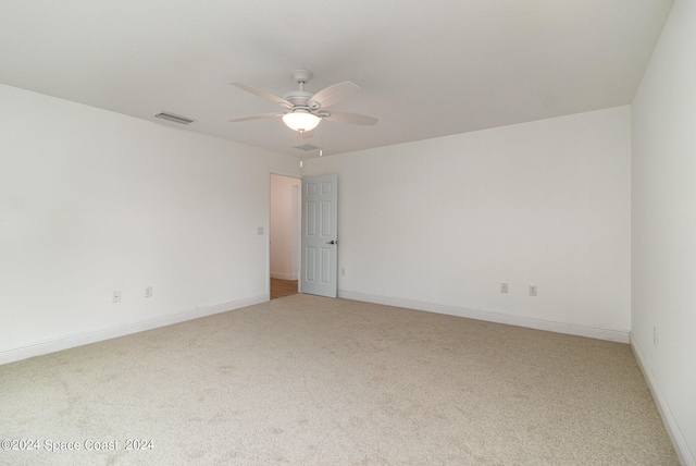 spare room featuring carpet floors and ceiling fan