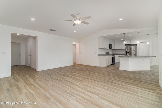 unfurnished living room with light wood-type flooring, lofted ceiling, and ceiling fan