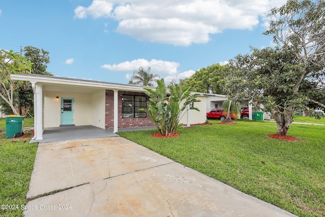 single story home featuring a front lawn and a carport