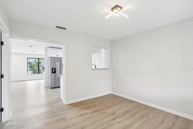 unfurnished room featuring light hardwood / wood-style flooring