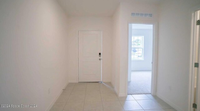 hallway with light tile patterned floors