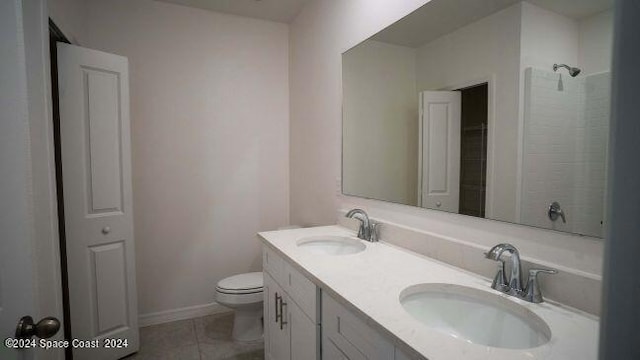 bathroom with tile patterned flooring, a shower, vanity, and toilet