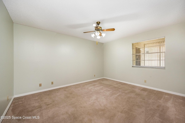 unfurnished room with baseboards, light colored carpet, and ceiling fan