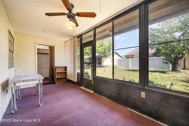 sunroom / solarium featuring a ceiling fan