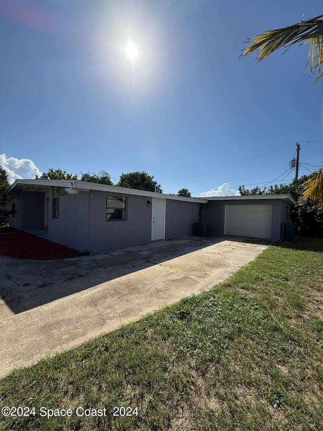 view of front of property with a garage and a front yard