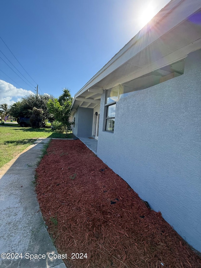 view of property exterior with a lawn