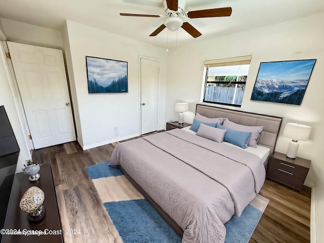 bedroom with dark wood-type flooring and ceiling fan