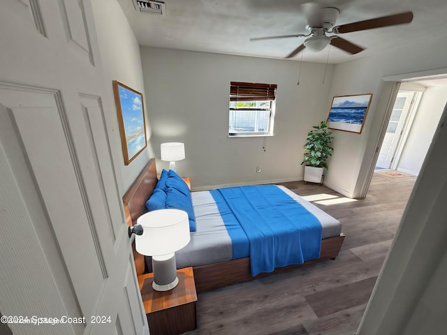 bedroom featuring ceiling fan and dark hardwood / wood-style floors