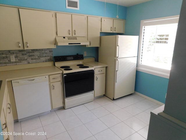 kitchen featuring white appliances, light countertops, cream cabinets, under cabinet range hood, and visible vents