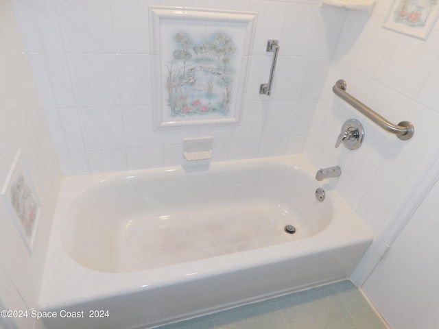 bathroom with a tub to relax in