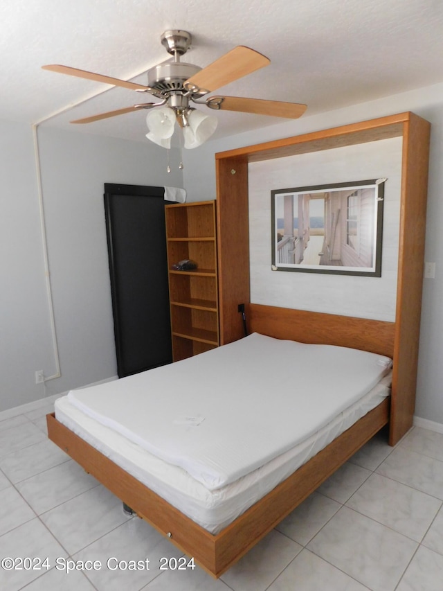 bedroom with baseboards, a ceiling fan, and light tile patterned flooring