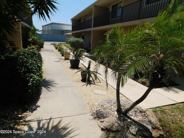 view of side of home featuring a balcony