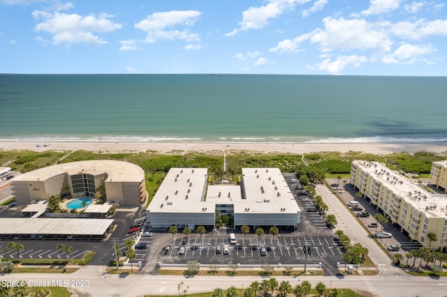 bird's eye view featuring a water view and a beach view