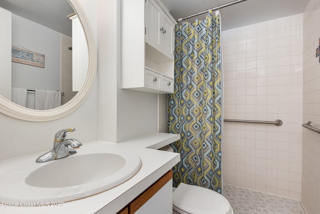 bathroom featuring toilet, curtained shower, and vanity