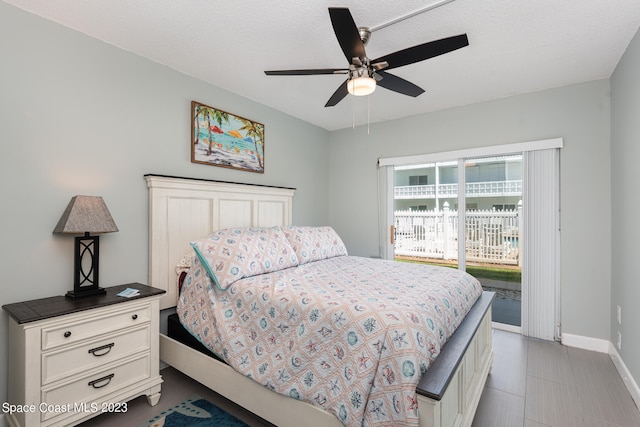 bedroom with a textured ceiling, access to outside, and ceiling fan