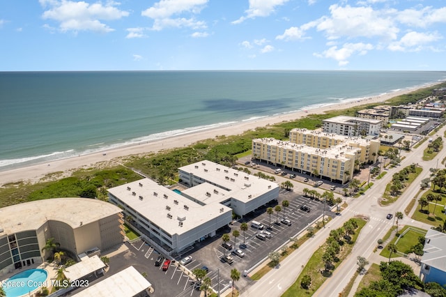 birds eye view of property with a water view and a view of the beach