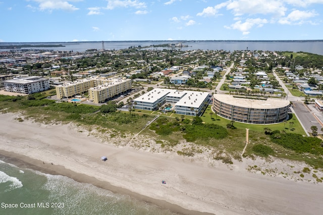 drone / aerial view with a water view and a view of the beach