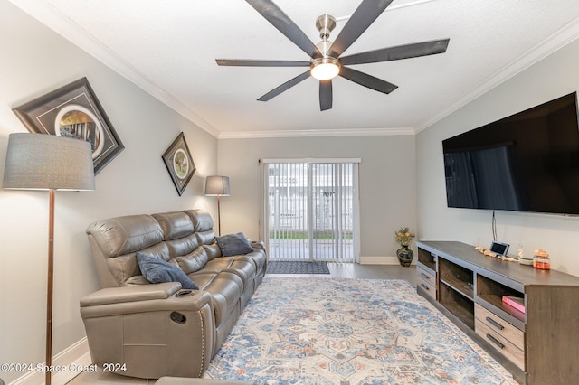 living room with ornamental molding and ceiling fan