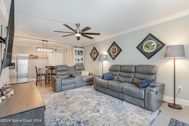 living room featuring crown molding, a textured ceiling, and ceiling fan