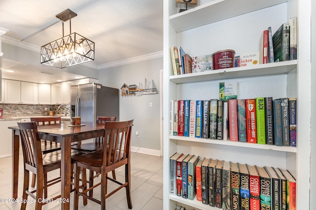 dining area with ornamental molding and an inviting chandelier