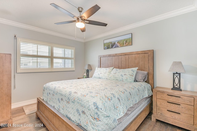 bedroom with ceiling fan, crown molding, and light hardwood / wood-style floors