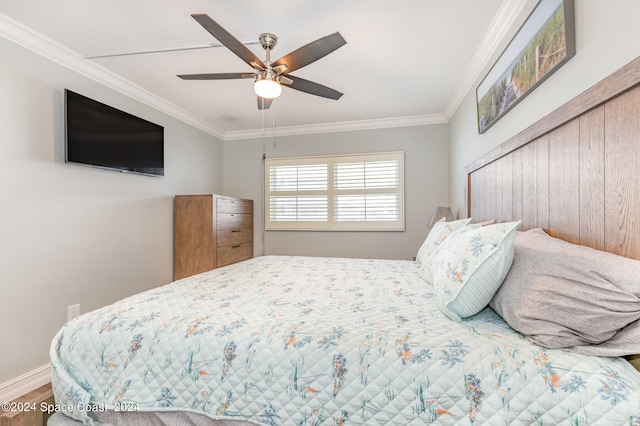 bedroom featuring crown molding, hardwood / wood-style floors, and ceiling fan