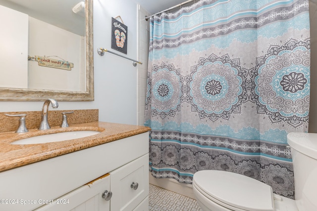 bathroom with vanity, curtained shower, toilet, and tile patterned floors