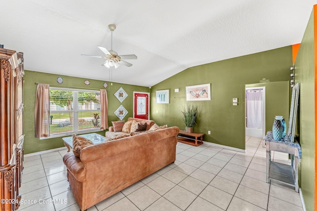 tiled living room featuring ceiling fan and vaulted ceiling